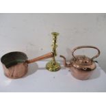 A beaten copper saucepan, copper kettle and a single brass candlestick