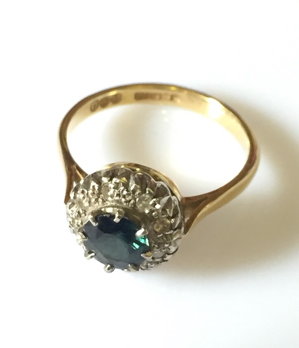 A 18ct gold ring with central sapphire and a diamond surround. - Image 3 of 3