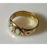 An Edwardian 18ct gold ring with opals.