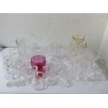 A collection of various glassware including cranberry glass