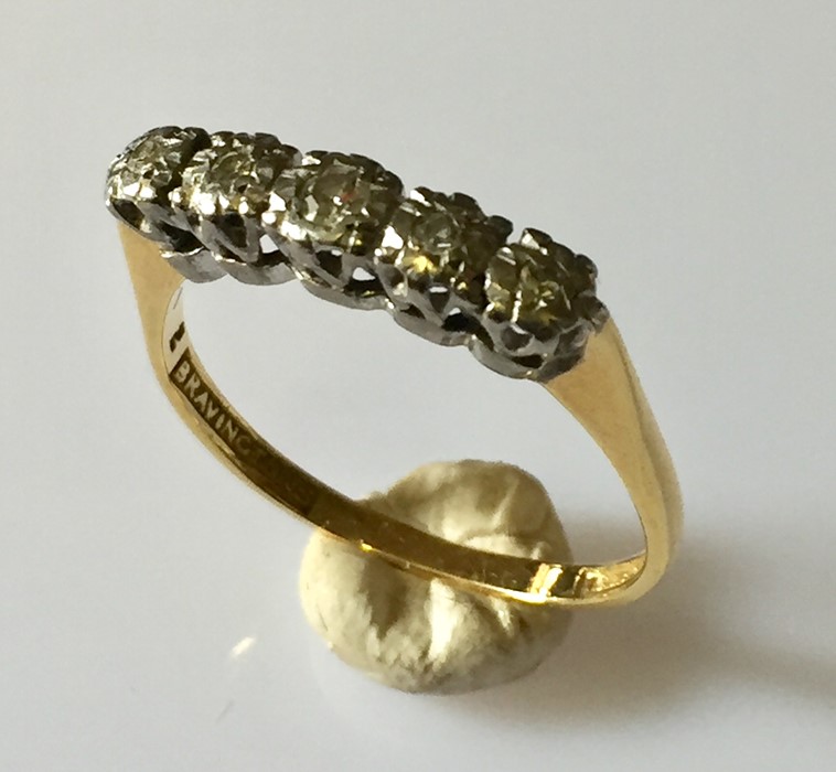 an 18ct gold ring with 5 diamonds.