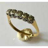 an 18ct gold ring with 5 diamonds.