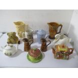 A collection of jugs, tea pots etc.including Wade