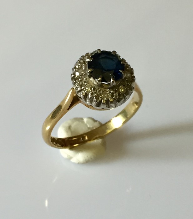 A 18ct gold ring with central sapphire and a diamond surround. - Image 2 of 3
