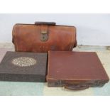 A leather satchel along with a small leather case and a carved box