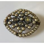 A Georgian brooch set with 4 irregular shaped old mine cut diamonds, the largest approx 0.75ct,