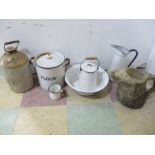 A small collection of enamelled ware along with an Esso jug and a stoneware flagon
