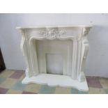 An ornate classical style marble effect fire surround and hearth