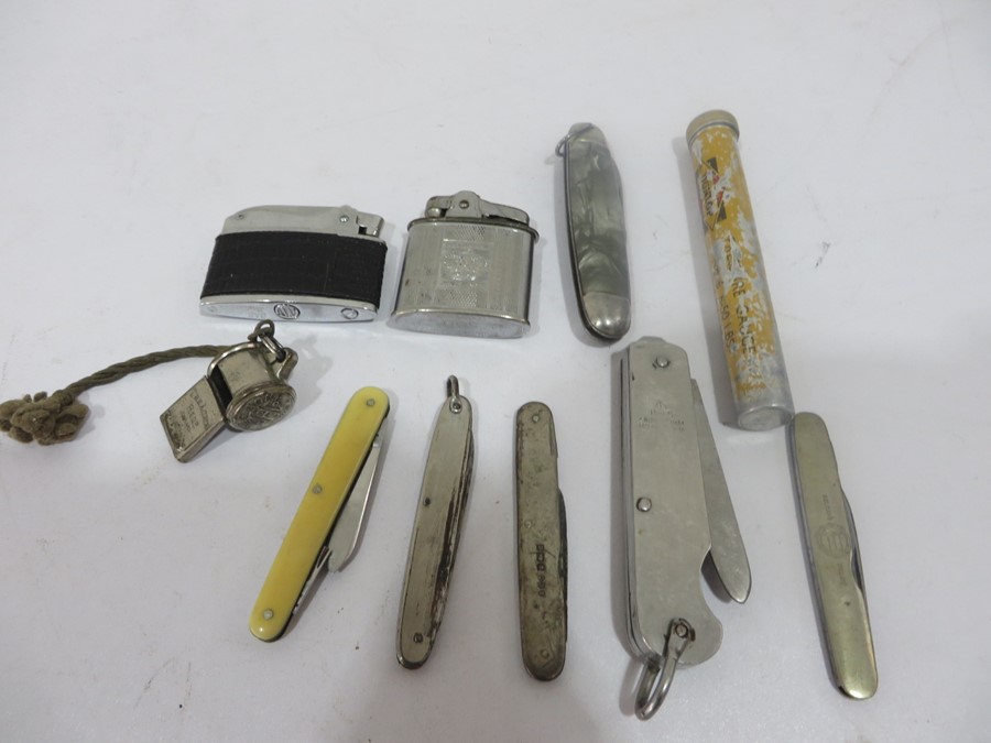 A collection of pen knives, lighters etc including a hallmarked silver penknife and 1945 penknife