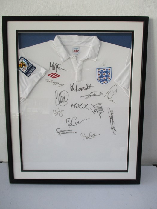 A 2009/10 England football shirt, framed and signed by various members of the team including Rooney,