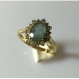 An 18ct gold ring with blue topaz and diamonds.