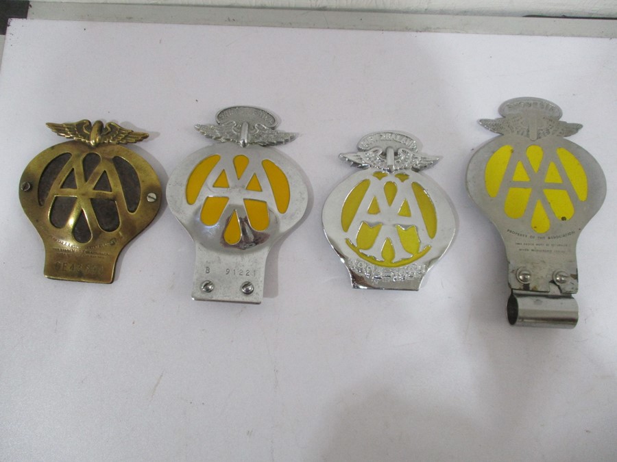 Four vintage AA badges including Rhodesia, South Africa, New Zealand and a brass version