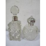 A silver topped scent bottle (London 1915) along with one other with silver collar (London 1919)