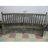 A large vintage curved wooden bench- in need of slight attantion