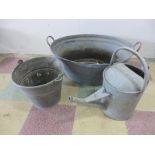 A galvanised bath, bucket and watering can