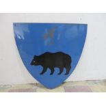 A shield shaped enamelled sign with logo of a bear