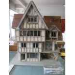 A handmade Medieval style dolls house 1:24th scale with some figures/ furniture etc.