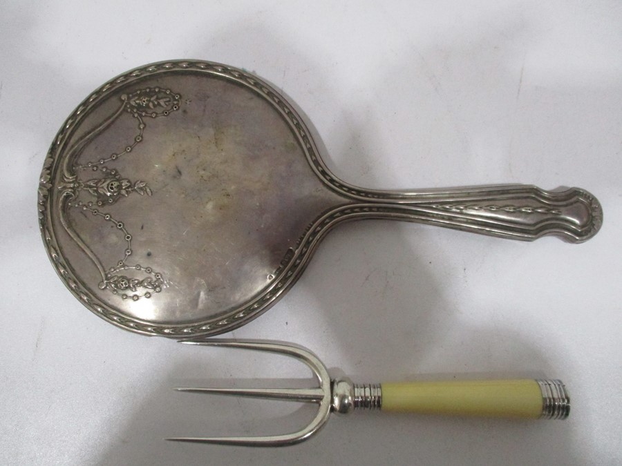 A hallmarked silver dressing table mirror along with a silver plated muffin fork