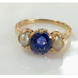 A good sapphire and pearl 3 stone ring set in unmarked gold (probably 18ct). The cornflower blue