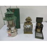 A Coleman lantern in case along with a brass lantern and small gas burner