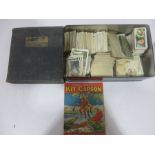 A collection of various cigarette cards and an album