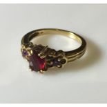 A 9ct gold garnet and amethyst 3 stone ring