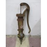 A wall mounted cast iron hand operated pump