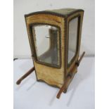 A late 19th century miniature silk covered bijouterie cabinet in the form of a sedan chair