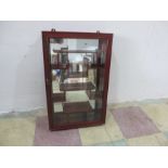 An oriental wall hanging display cabinet