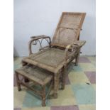 An adjustable wicker and bamboo plantation chair with built in foot rest by Army & Navy C.S.L