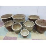 A collection of 8 garden pots