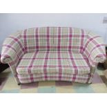 A kidney shaped upholstered sofa