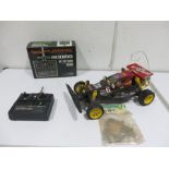 A Tamiya Falcon RC car with remote