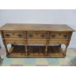 An oak dresser with potboard base and crossbanded decoration