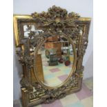 A large ornate gilded mirror with foliate swags