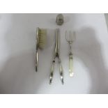 A silver bread fork with mother of pearl handle, silver handled glove stretchers, sterling silver