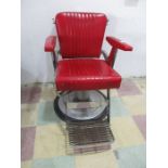 A mid century Belmont barbers chair in red vinyl with adjustable back rest- hydraulics seem to be in