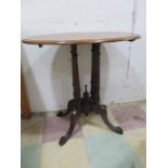 A Victorian oval occasional table on four column legs