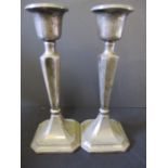 A pair of hallmarked silver candlesticks, approx 15cm height