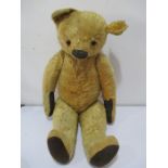 A large vintage plush teddy bear with jointed arms and legs- A/F