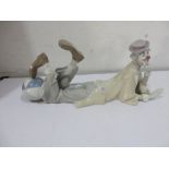 A Lladro figure of a clown lying down playing with a ball