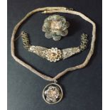 A silver filigree necklace, bracelet and brooch.