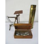 A set of weighing scales, brass shell along with a box containing a small amount of silver plated