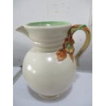 A Clarice Cliff jug with relief moulded floral handle 22.5cm height