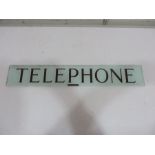 A glass telephone box sign