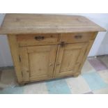 An antique pine cupboard with two drawers