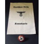 A Nazi party badge along with an identity card stamped 1940