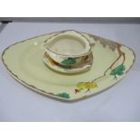 A Clarice Cliff diamond shaped meat plate and gravy boat and stand