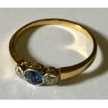 An 18ct gold, diamond and cornflower blue sapphire 3 stone ring.