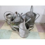 Four galvanised watering cans